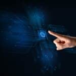 Hand touching a glowing blue fingerprint icon set within a neon circuitry background, depicting biometric security.